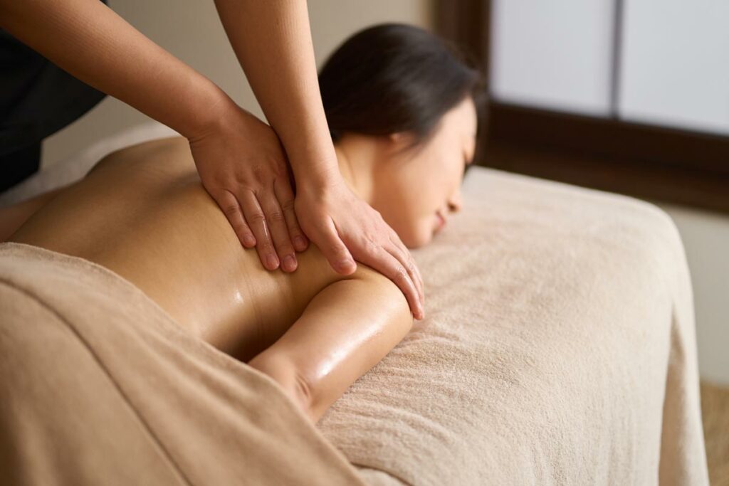 Woman on a table receiving a traditional Chinese massage