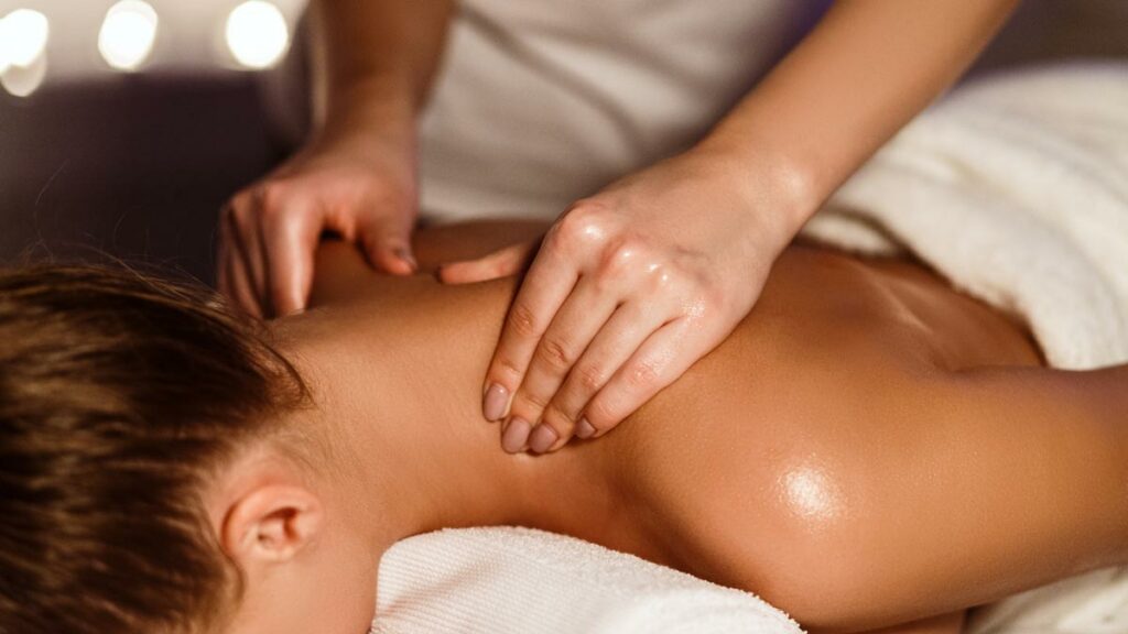 Hands giving woman a neck massage